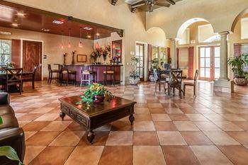 A large room with a table and chairs in it.